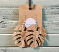 Wooden leaf-shaped earrings on a cardboard backing with 'Salty Bae' branding.